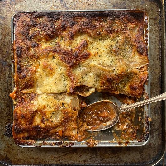 Homemade Lasagna cooked from scratch in a glass dish with a herby spice mix Baqa