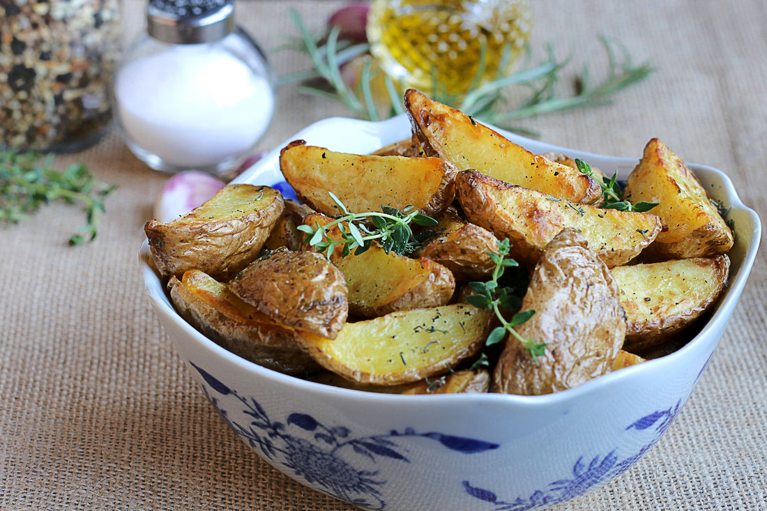 Spiced potato wedges in a blue and wite bowl